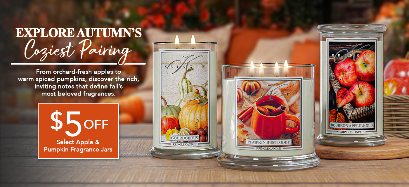 Three candles with autumn-themed labels on a wooden surface, with a promotional banner for a $5 off discount.
