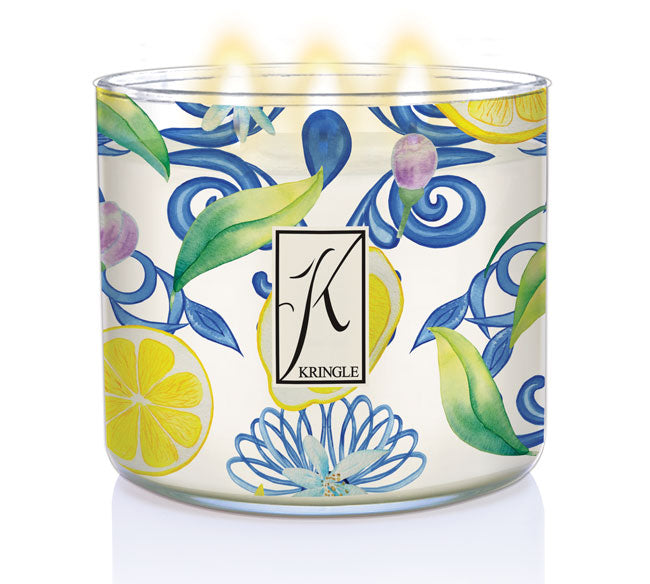 Kringle Candle Aegean Zest Large 3-Wick Candle – A wide glass jar candle with a metallic lid, featuring an elegant watercolor-inspired design of lemons, green leaves, and swirling blue floral patterns. The ‘Kringle’ logo is displayed in the center on a rectangular label. The candle contains white wax, housed in a decorative jar that complements its fresh, citrus fragrance.
