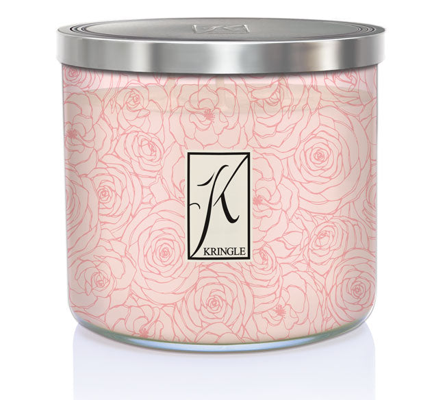 Pink candle in a jar with rose line art design and a silver lid, labeled