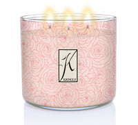 White candle with pink rose pattern in a glass jar, labeled "Kringle," with five flames lit on top.