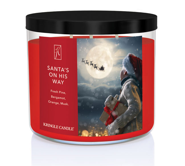 Kringle Candle Christmas-themed candle with Santa Claus and reindeer design on a white background