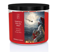 Kringle Candle Christmas-themed candle with Santa Claus and reindeer design on a white background