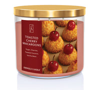 Kringle Candle Toasted Cherry Macaroons candle with a gold lid on a white background