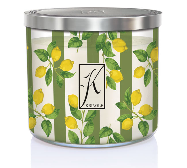 Candle in jar with green and white stripes, decorated with yellow lemons and green leaves. Silver lid on top.
