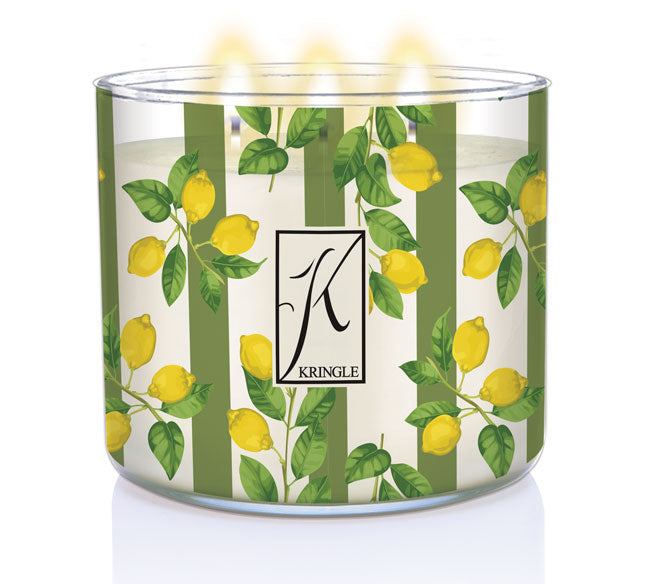 Lit candle in a glass jar with green stripes and yellow lemons. The logo reads "Kringle" with decorative text.