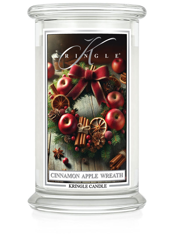 Candle in large jar with cinnamon apple wreath design, featuring apples, cinnamon sticks, and pinecones.