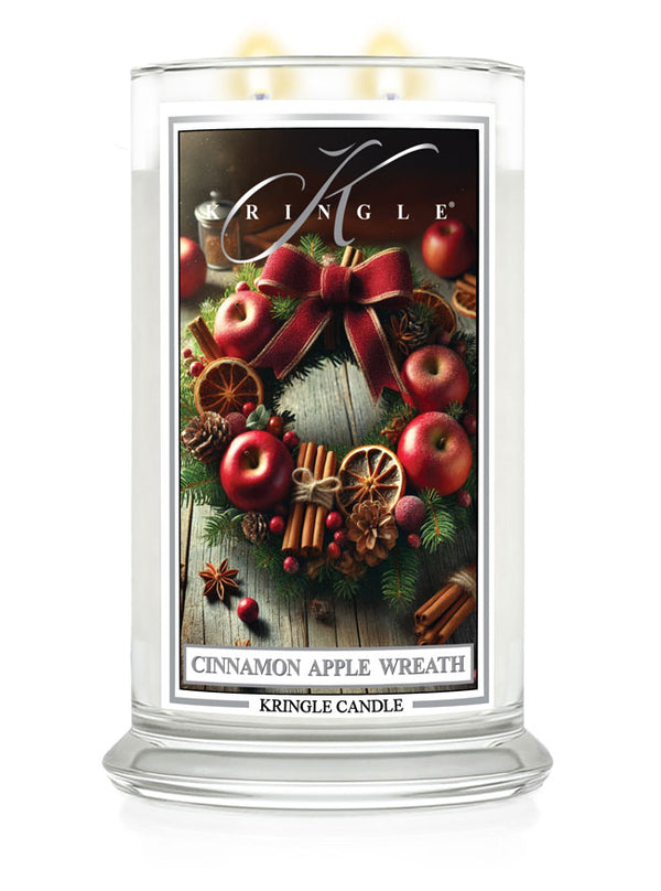 Kringle Candle large jar with a "Cinnamon Apple Wreath" label featuring apples, cinnamon sticks, and festive decor.