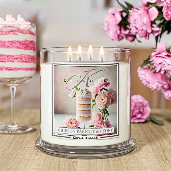 Glass lit candle jar with label featuring layered dessert, pink peonies, and elegant script reading "Chiffon Parfait & Peony."