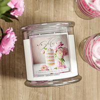 Glass candle jar with label featuring layered dessert, pink peonies, and elegant script reading "Chiffon Parfait & Peony."