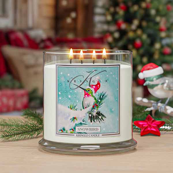 Kringle Candle Snowbird 4-wick candle with festive design in a Christmas setting