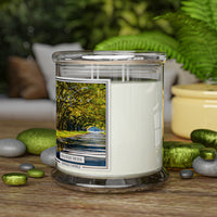 A candle jar with a label showing a tree-lined path. It reads "Spanish Moss, Kringle Candle."