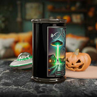 Candle in a black container with a Halloween-themed label featuring a UFO and pumpkin, set against a festive background.
