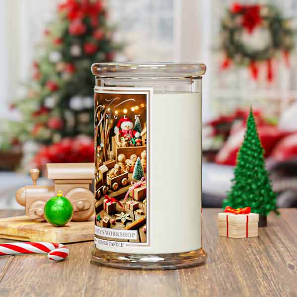 Decorative candle with a Christmas-themed label on a table with festive decorations.