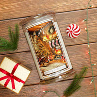 Decorative Vintage Christmas candle with Christmas scene on a wooden surface with a gift and candy cane.