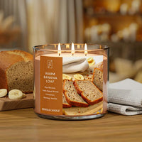 Kringle Candle with 'Warm Banana Loaf' scent on a wooden surface with bread and bananas in the background.