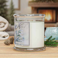 Kringle Candle Winter Cypress  4-wick candle on a table with a fireplace in the background