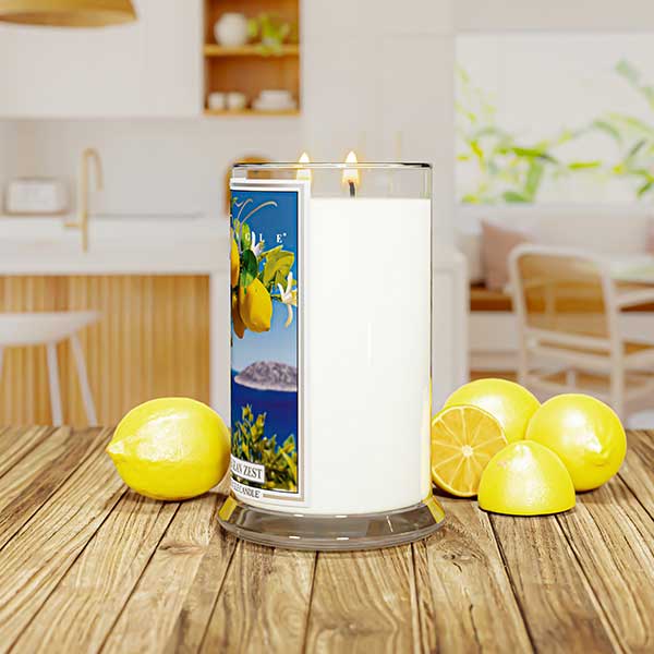 Lit candle labeled "Aegean Zest" with lemons and ocean scene, set in a colorful room with green, yellow decor.