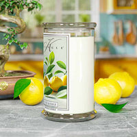Glass jar candle with label showing yellow yuzu fruits and green leaves. Text: "Yuzu & Sage," "Kringle Candle."