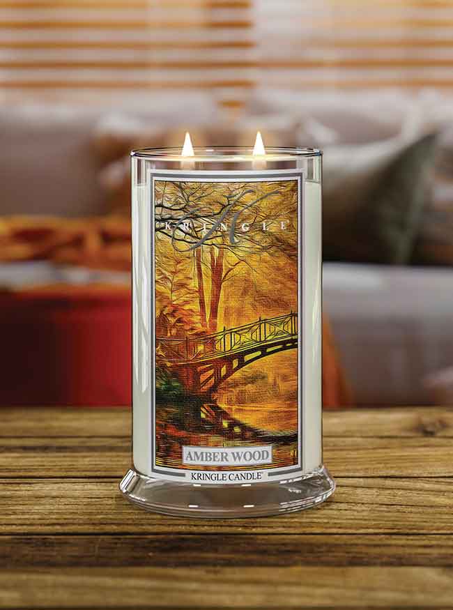 Amber Wood  Large 2-wick lit autumn candle on a table  - Kringle Candle Company