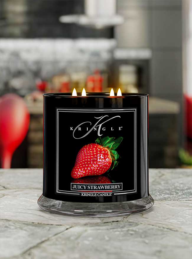 Juicy Strawberry 4-wick lit candle on a kitchen counter from Kringle Candle Reserve Collection