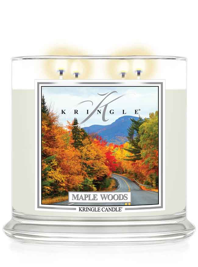 Kringle Candle Maple Woods scented 4-wick lit candle with a fall scene label on a white background
