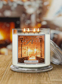 Kringle Candle with 'Snowy Bridge' design on a wooden surface with a blurred background