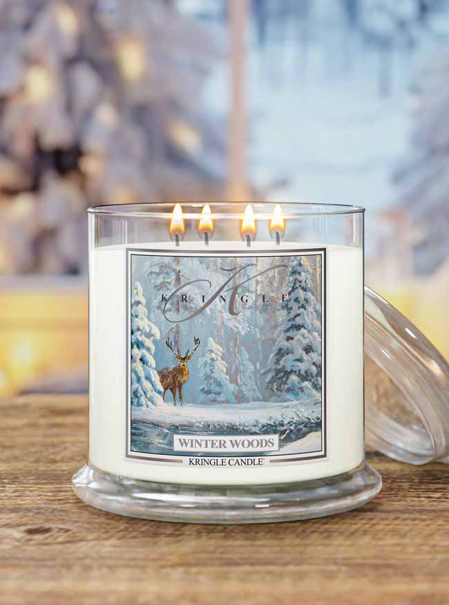 Kringle Candle with 'Winter Woods' design on a wooden surface with blurred background