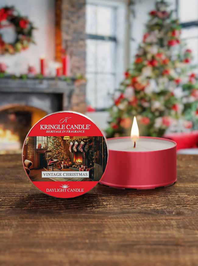 Kringle Candle daylight candle with Christmas-themed packaging on a wooden surface.
