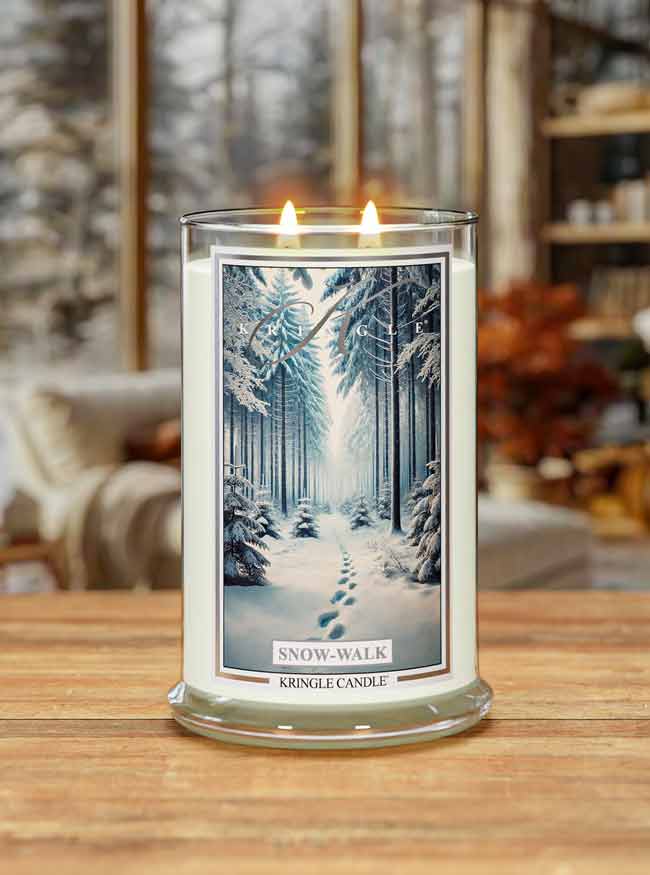 Kringle Candle 'Snow Walk' candle on a wooden surface with a winter scene label