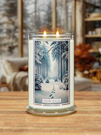 Kringle Candle 'Snow Walk' candle on a wooden surface with a winter scene label