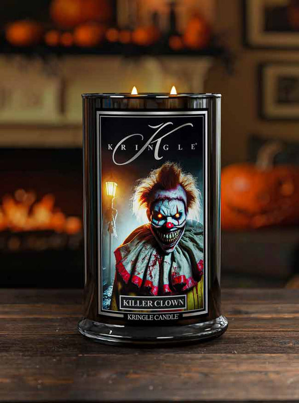 Kringle Candle with a 'Killer Clown' design on a wooden surface with pumpkins in the background.