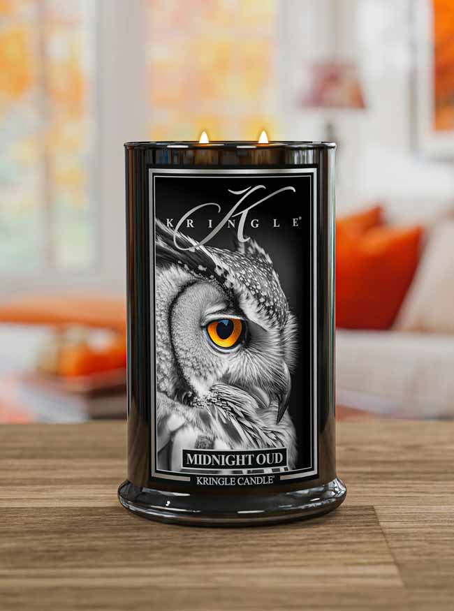 Kringle Candle with owl design on a wooden surface