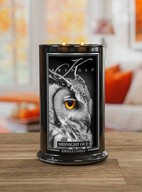 Kringle Candle with owl design on a wooden surface