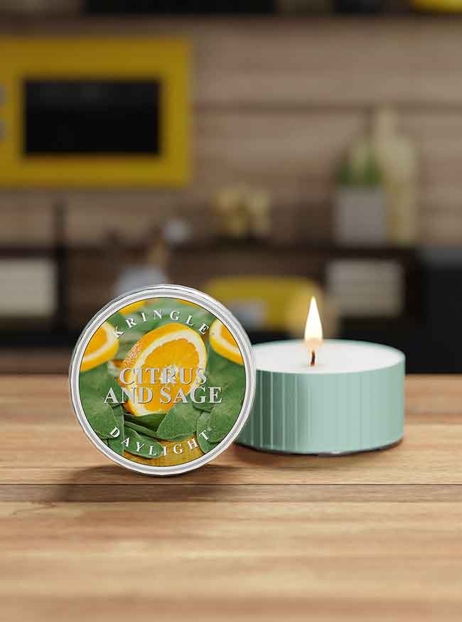 Candle with 'Citrus and Sage' packaging on a wooden surface