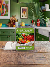 "Kringle Candle wax melts with tomatoes and greens image, set on a wooden counter in a green kitchen."