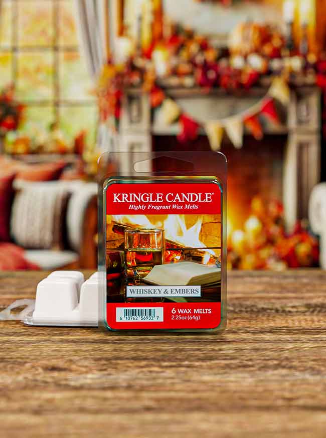 Packaging for "Whiskey & Embers" wax melts. The label shows a whiskey glass by a roaring fireplace.