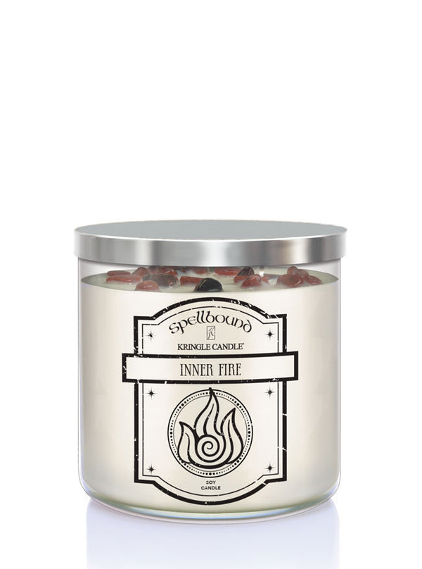 Spellbound Inner Fire candle with silver lid on a white background showing front of candle
