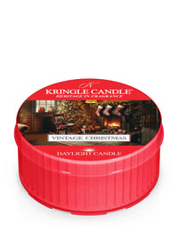 Red Kringle Candle daylight labeled "Vintage Christmas," featuring a cozy holiday scene with a tree and fireplace.