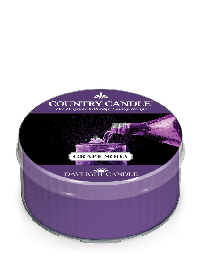 Purple Country Candle tin labeled "Grape Soda Daylight Candle," featuring a splash image of pouring grape soda.
