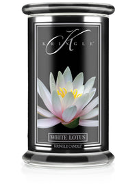 A candle jar labeled "White Lotus" with an image of a blooming white lotus flower on a black background.