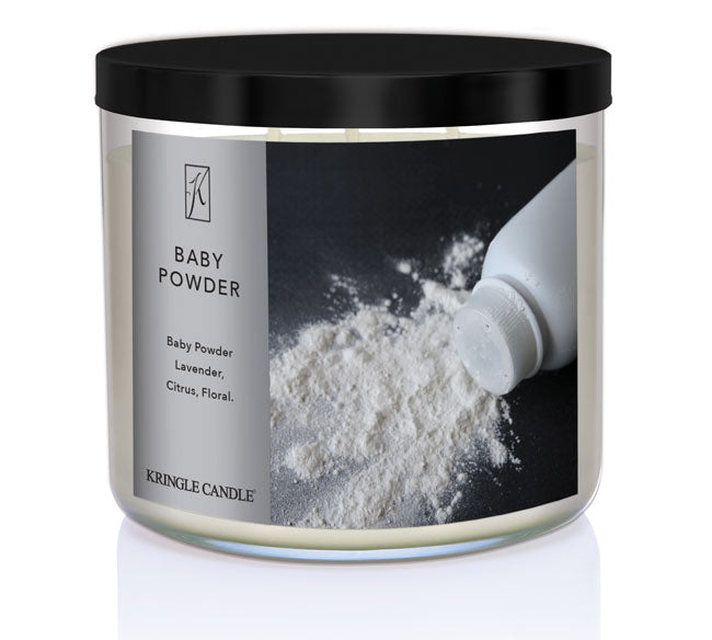 A three-wick candle in a clear glass jar with a black lid and a classic powder-themed label. The label features a bottle of baby powder spilling onto a dark surface. The candle’s wax is soft white, and the wicks are unlit. The scent notes listed are baby powder, lavender, citrus, and floral.