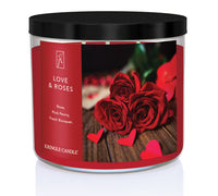 A three-wick candle in a clear glass jar with a black lid and a romantic floral-themed label. The label features a close-up of red roses on a wooden surface with scattered red heart-shaped confetti. The candle’s wax is deep red, and the wicks are unlit. The scent notes listed are rose, pink peony, and fresh bouquet.