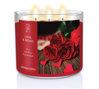 A three-wick lit candle in a clear glass jar with a romantic floral-themed label. The candle’s wax is deep red, and all three wicks are burning.