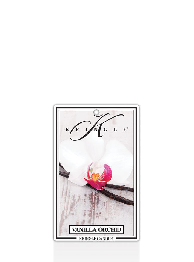 Kringle Candle Vanilla Orchid air freshener, designed for use in cars or small spaces. The packaging features a white orchid with a pink and yellow center resting on a vanilla bean, set against a rustic wood background. The Kringle Candle logo is displayed at the top, with the scent name ‘Vanilla Orchid’ printed below.