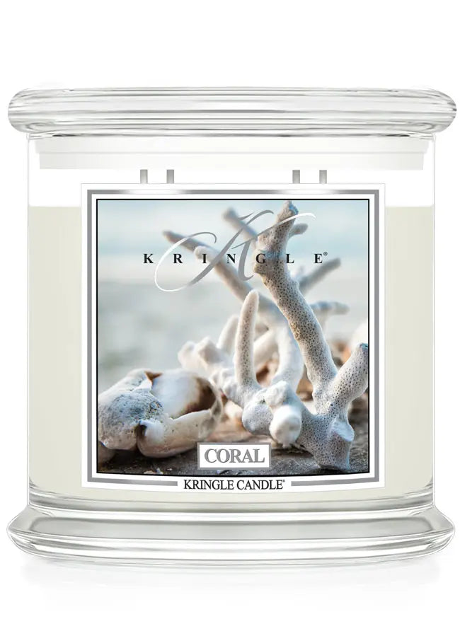Kringle Candle jar in Coral scent featuring a coastal image of white coral branches on a beach.