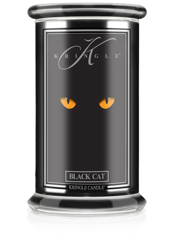 Unlit Halloween candle in glass jar. Label shows glowing yellow cat eyes on black background. Text reads "Black Cat."