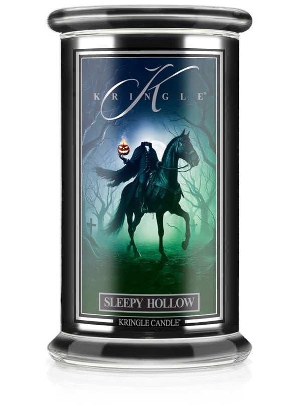 Unlit Halloween "Sleepy Hollow" candle jar. Label shows a headless horseman holding a jack-o'-lantern in a spooky forest.