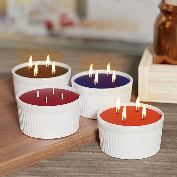 Kringle Candle Ramekins in a variety of colors and fragrances; shows 4 candles lit with 4 wicks in each candle.