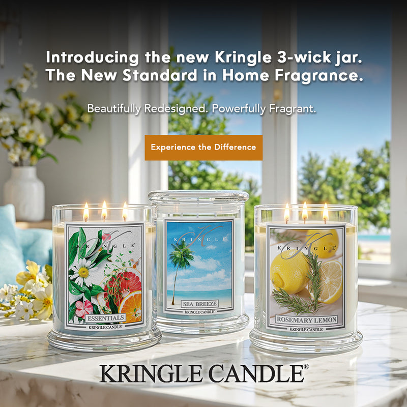 Three Kringle Candle 3-wick jars on a table with scenic background