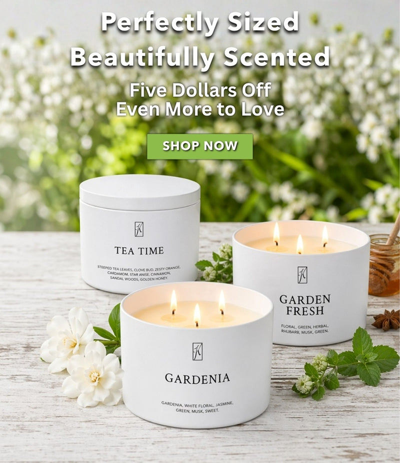 Three scented candles on a wooden surface with flowers and text promoting a sale.